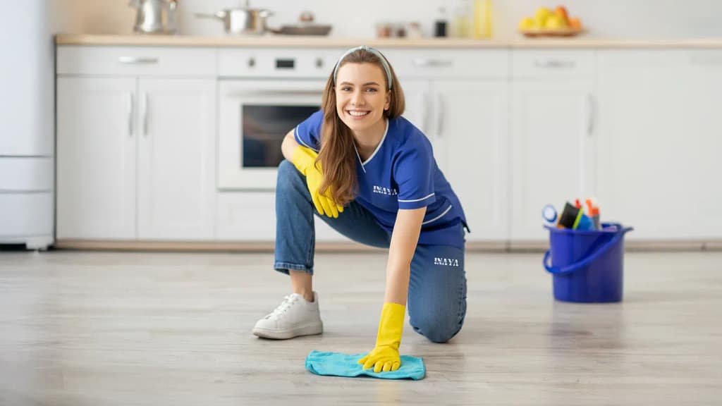 Maid sweeping hallway floor