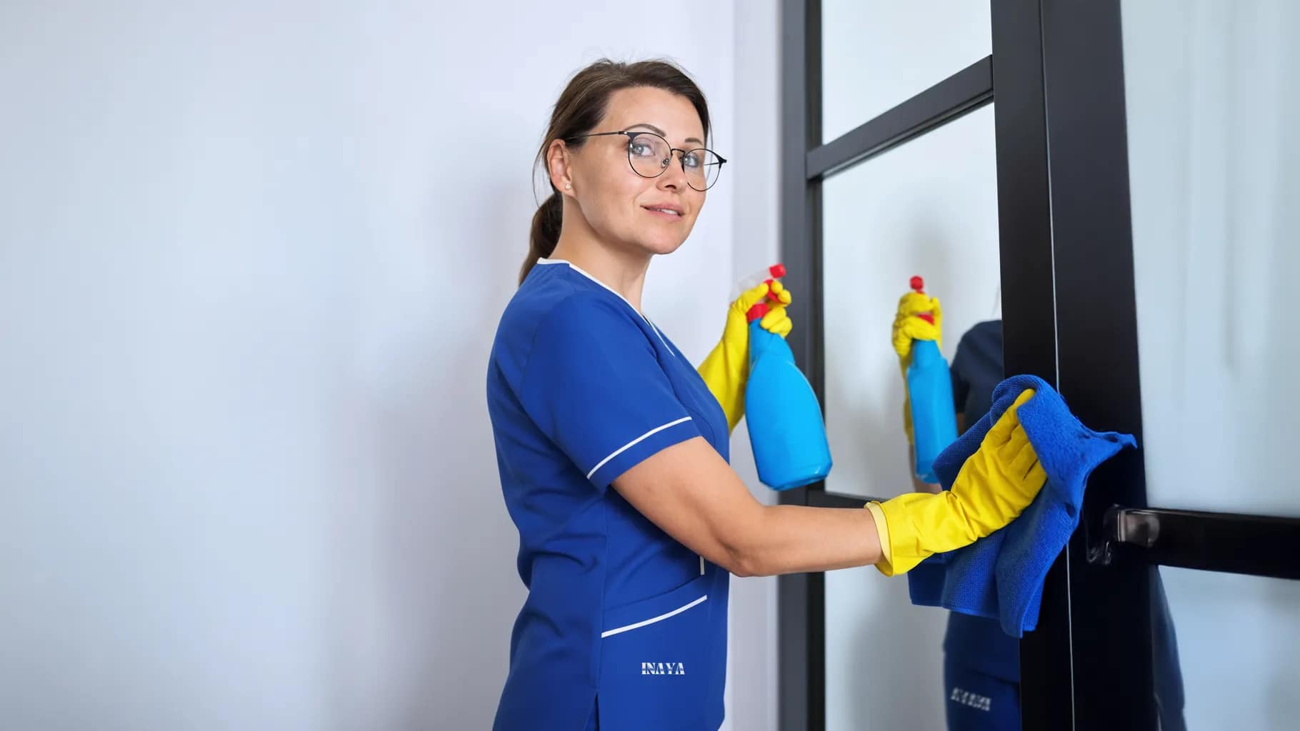 Maid wiping dust from furniture